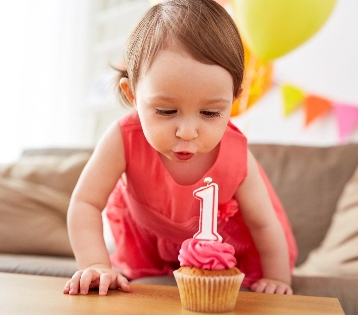 toddler blowing candle